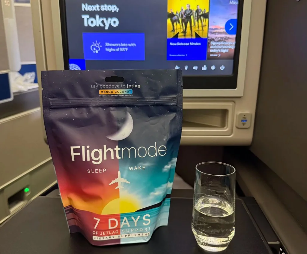 Flightmode pack on an airplane tray table during a long-haul flight